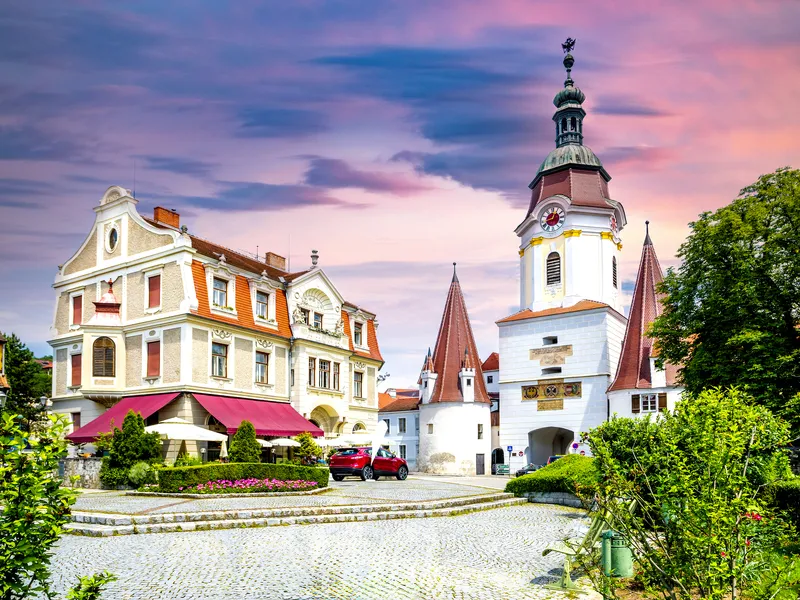 Malerische Altstadt mit Kirche und historischem Gebäude bei Sonnenuntergang.